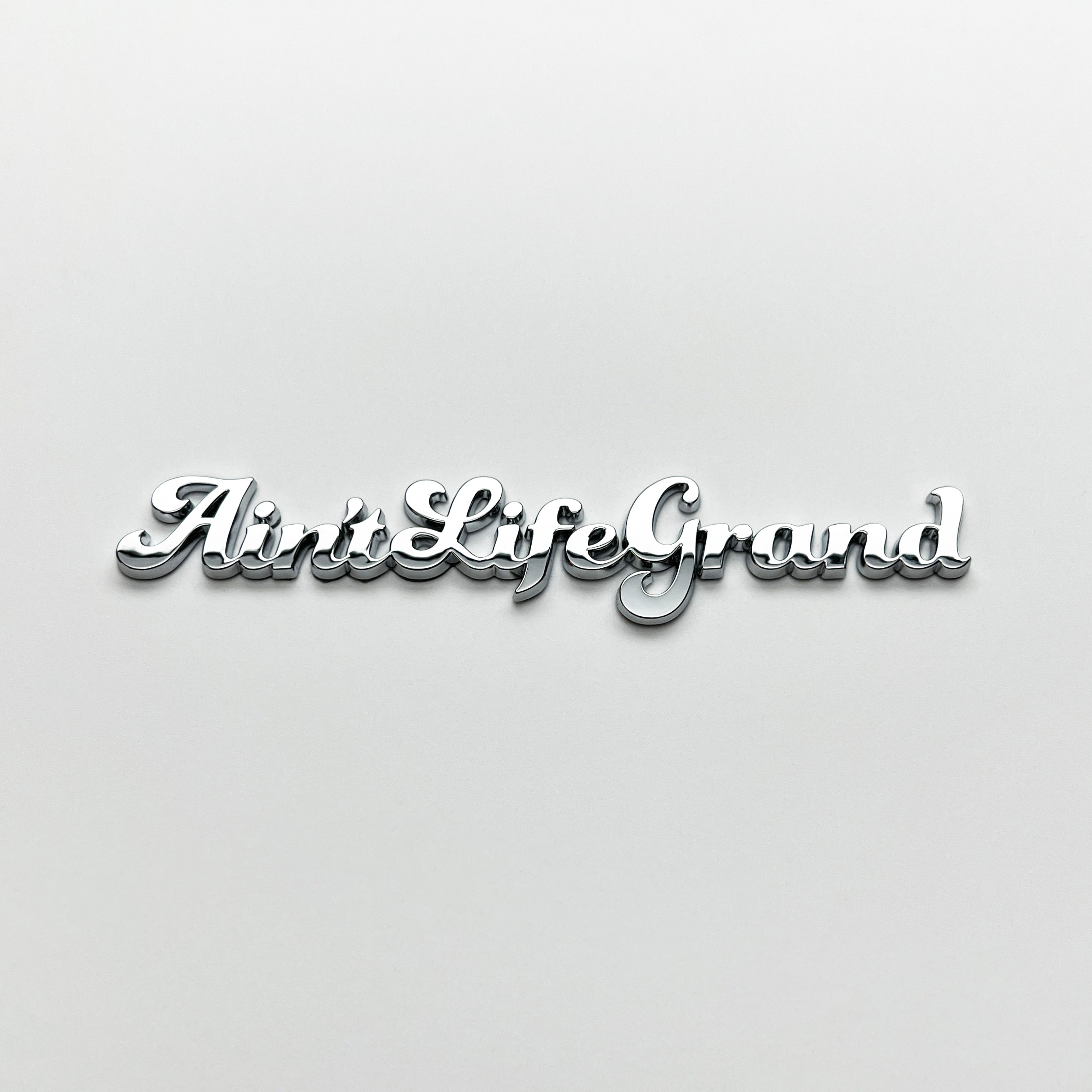 the AIN'T LIFE GRAND BADGE - Grateful Fred - Vehicle Emblems & Hood Ornaments