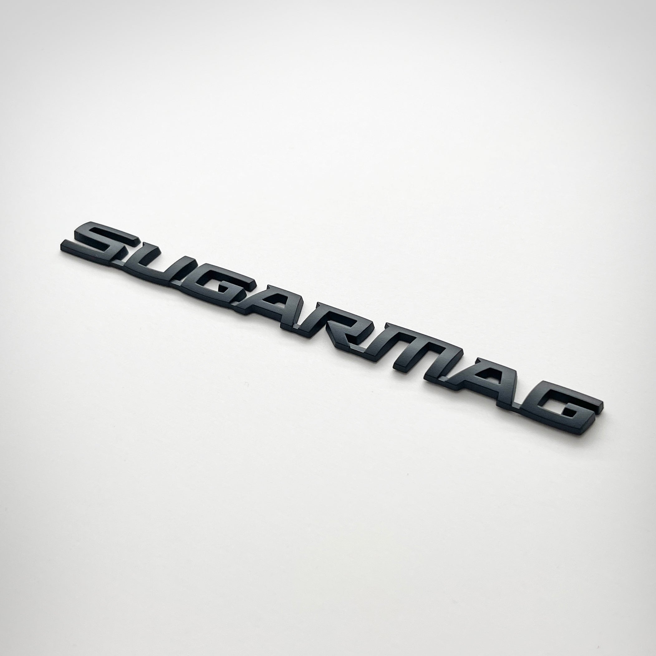 the SUGAR MAG BADGE - Grateful Fred - Vehicle Emblems & Hood Ornaments