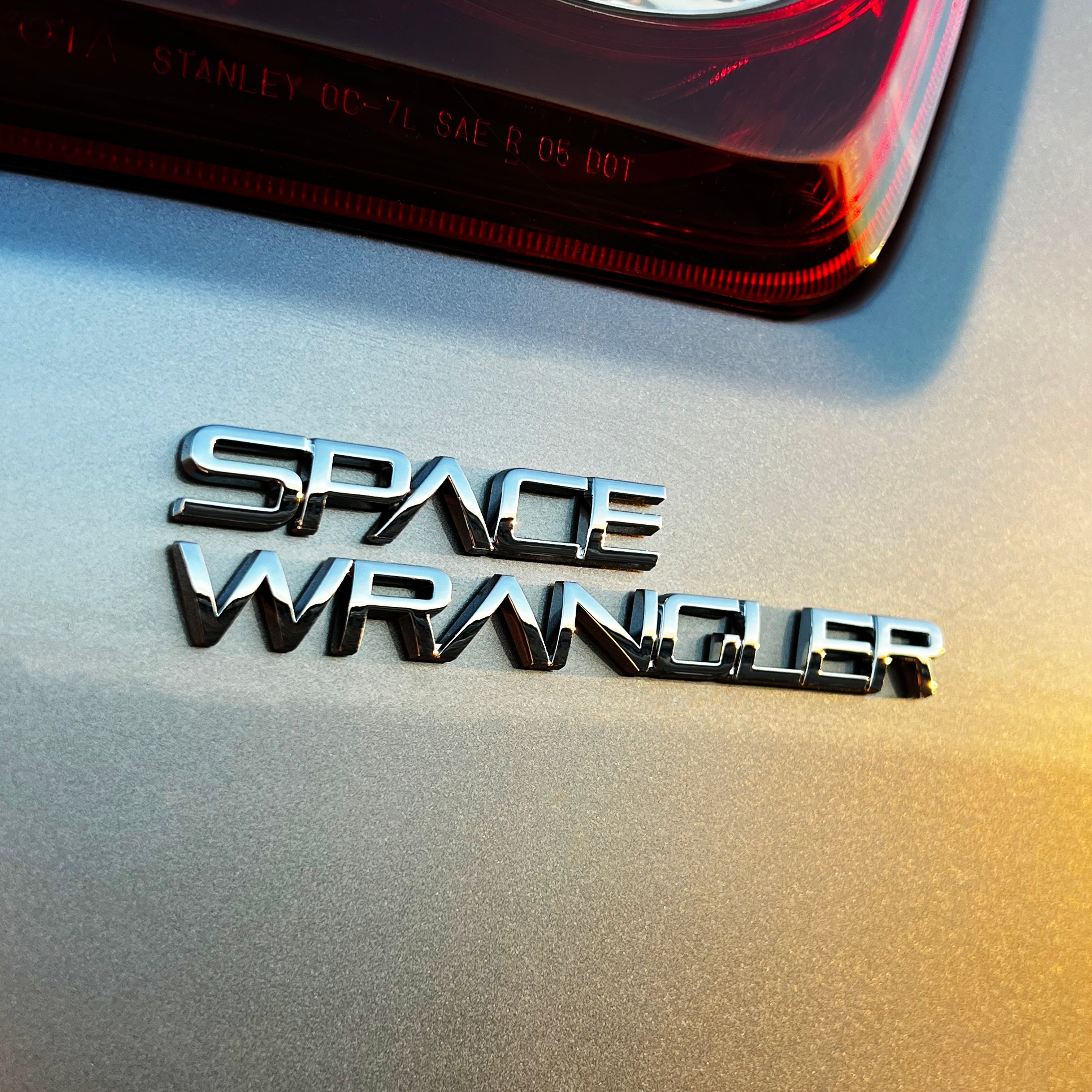 the SPACE WRANGLER BADGE - Grateful Fred - Vehicle Emblems & Hood Ornaments