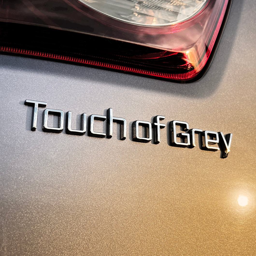 the TOUCH OF GREY BADGE - Grateful Fred   - Vehicle Emblems & Hood Ornaments